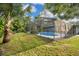 Screened-in pool with surrounding lush greenery at 235 Oakdale St, Windermere, FL 34786