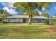 Back of house, showcasing a large yard and mature trees at 235 Oakdale St, Windermere, FL 34786