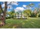 Side view of a charming single story home with mature trees at 235 Oakdale St, Windermere, FL 34786