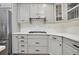 Modern kitchen with gray cabinets, white backsplash, and gas stove at 235 Oakdale St, Windermere, FL 34786