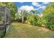 Spacious backyard with lush landscaping and a screened enclosure at 235 Oakdale St, Windermere, FL 34786