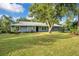 Ranch style home with lush lawn and mature trees at 235 Oakdale St, Windermere, FL 34786