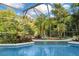 Refreshing screened pool surrounded by lush landscaping at 235 Oakdale St, Windermere, FL 34786