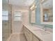 Bathroom with double sinks, glass shower, and updated vanity at 235 Oakdale St, Windermere, FL 34786