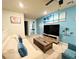 Bright living area with a TV, comfy seating, and tropical decor at 710 Gardenia Ln, Davenport, FL 33897