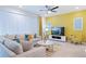 Living room with sectional sofa, coffee table, and a large TV at 710 Gardenia Ln, Davenport, FL 33897