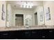 Double vanity bathroom with granite countertop and a large mirror at 710 Gardenia Ln, Davenport, FL 33897