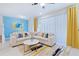 Spacious living room featuring a large sectional sofa and stylish decor at 710 Gardenia Ln, Davenport, FL 33897