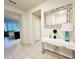Bright and airy entryway with a white console table and large mirror at 710 Gardenia Ln, Davenport, FL 33897