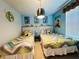 Twin bedroom with Minions-themed decor and bright bedding at 710 Gardenia Ln, Davenport, FL 33897