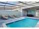 Private pool and patio with lounge chairs and dining set at 710 Gardenia Ln, Davenport, FL 33897