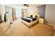 Main bedroom with king-size bed, crib, and neutral decor at 710 Gardenia Ln, Davenport, FL 33897