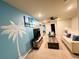 Cozy living area with a TV, comfy couch and unique wall art at 710 Gardenia Ln, Davenport, FL 33897