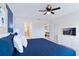 Spacious main bedroom with ensuite bathroom access, TV, and plenty of light at 710 Gardenia Ln, Davenport, FL 33897
