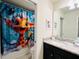 Small bathroom with giraffe-themed shower curtain at 710 Gardenia Ln, Davenport, FL 33897