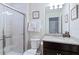 Bathroom with shower, granite vanity and neutral decor at 710 Gardenia Ln, Davenport, FL 33897