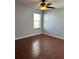 Bright bedroom with wood floors, ceiling fan, and window at 5225 Creekside Park Ave, Orlando, FL 32811