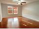 Bright bedroom with hardwood floors and large windows at 5225 Creekside Park Ave, Orlando, FL 32811