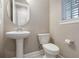 Small bathroom with pedestal sink and toilet at 1577 Castile St, Celebration, FL 34747