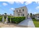 Stunning two-story home with gated driveway and manicured hedges at 424 Pelican Ave, Daytona Beach, FL 32118