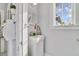 Small bathroom with white vanity, window, and patterned floor at 424 Pelican Ave, Daytona Beach, FL 32118