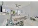 Bright bedroom with white platform bed, ceiling fan, and wood-look floors at 424 Pelican Ave, Daytona Beach, FL 32118