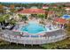 Community pool with surrounding deck, lounge chairs, and a clubhouse at 105 Pompano Beach Dr, Kissimmee, FL 34746