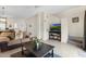 Living room with sofa, coffee table, and stairs leading upstairs at 105 Pompano Beach Dr, Kissimmee, FL 34746