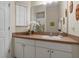 Bathroom with single sink vanity, shower, and decorative accents at 105 Pompano Beach Dr, Kissimmee, FL 34746