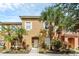 Tan two-story townhouse with white shutters and palm trees at 105 Pompano Beach Dr, Kissimmee, FL 34746