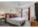 Bedroom with a queen bed, nightstands, and ceiling fan at 105 Pompano Beach Dr, Kissimmee, FL 34746