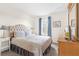Bedroom with a queen bed, nightstands, and a dresser at 105 Pompano Beach Dr, Kissimmee, FL 34746