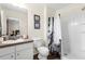 Bathroom with a toilet, single sink vanity, and shower at 105 Pompano Beach Dr, Kissimmee, FL 34746