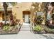 Front entrance of a tan townhouse with steps and landscaping at 105 Pompano Beach Dr, Kissimmee, FL 34746