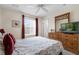 Bedroom with a queen bed, dresser, and ceiling fan at 105 Pompano Beach Dr, Kissimmee, FL 34746