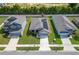 Aerial view of three homes with solar panels at 220 Bergamot Loop, Davenport, FL 33837