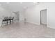 Open living room with tile floors and access to other rooms at 220 Bergamot Loop, Davenport, FL 33837