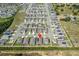 Aerial view of a house and community with solar panels and a pool at 220 Bergamot Loop, Davenport, FL 33837