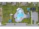 Community pool with plenty of lounge chairs and a playground nearby at 220 Bergamot Loop, Davenport, FL 33837