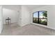 Bright bedroom featuring a large window and neutral carpeting at 220 Bergamot Loop, Davenport, FL 33837