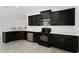 Modern kitchen with dark wood cabinets, stainless steel appliances, and quartz countertops at 220 Bergamot Loop, Davenport, FL 33837