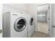 Laundry room with washer, dryer, and access to the garage at 220 Bergamot Loop, Davenport, FL 33837