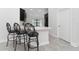 Modern kitchen island with seating for three and a sleek white countertop at 220 Bergamot Loop, Davenport, FL 33837