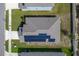 Aerial view of a house with solar panels on the roof at 220 Bergamot Loop, Davenport, FL 33837