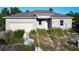 New construction home with block exterior and two-car garage at 619 Alafia Pl, Poinciana, FL 34759