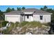 New construction home with block exterior and two-car garage at 619 Alafia Pl, Poinciana, FL 34759