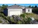 New construction home with block exterior and two-car garage at 619 Alafia Pl, Poinciana, FL 34759
