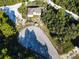 Aerial view of a home on a wooded lot with a driveway at 619 Alafia Pl, Poinciana, FL 34759