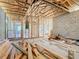 New home interior framing and electrical with wood scattered around at 619 Alafia Pl, Poinciana, FL 34759