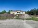 Newly constructed home with unfinished landscaping at 619 Alafia Pl, Poinciana, FL 34759